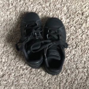 Worn adidas black shoes